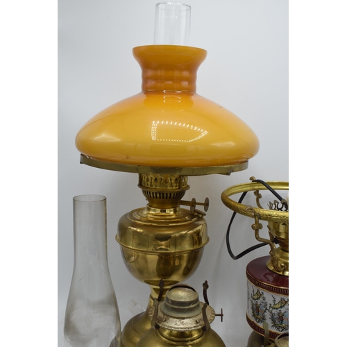 348 - A collection of vintage oil lamps to include brass and pottery examples with associated chimneys and... 