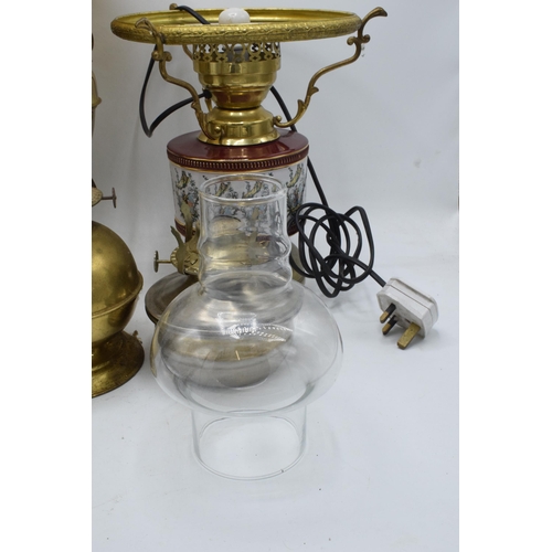 348 - A collection of vintage oil lamps to include brass and pottery examples with associated chimneys and... 