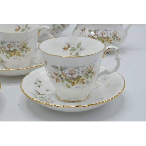 61 - A collection of Royal Albert tea ware in the Haworth design to include a tea pot, 12 cups and saucer... 