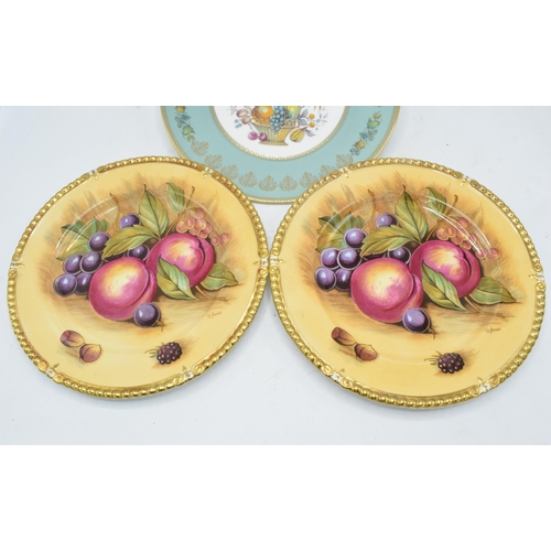 64 - A pair of Aynsley Orchard Gold 26.5cm diameter plates signed by D. Jones together with an Aynsley pl... 