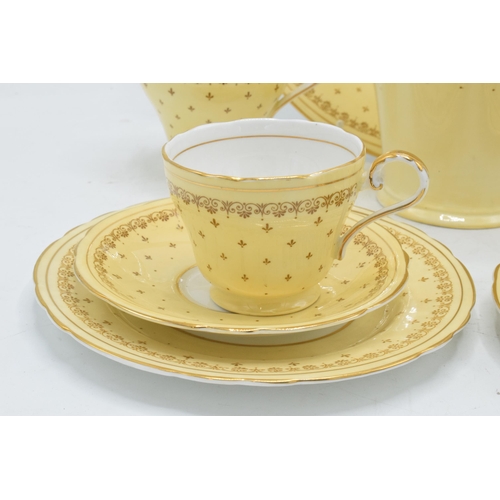 68 - Aynsley coffee set in a yellow and gold design to consist of a coffee pot, milk and sugar pot, 5 cof... 