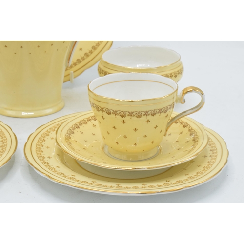 68 - Aynsley coffee set in a yellow and gold design to consist of a coffee pot, milk and sugar pot, 5 cof... 