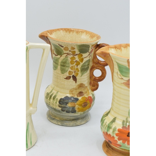 82 - A collection of Wade Heath Art Deco jugs all with floral decorations (5). 13.5cm tall. Generally in ... 