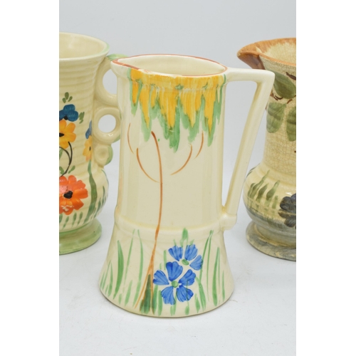 82 - A collection of Wade Heath Art Deco jugs all with floral decorations (5). 13.5cm tall. Generally in ... 