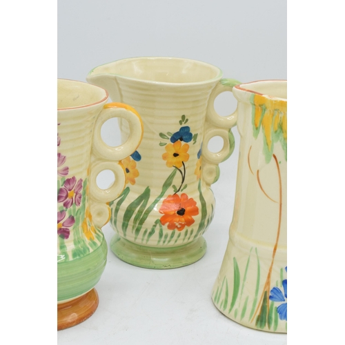 82 - A collection of Wade Heath Art Deco jugs all with floral decorations (5). 13.5cm tall. Generally in ... 