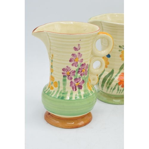 82 - A collection of Wade Heath Art Deco jugs all with floral decorations (5). 13.5cm tall. Generally in ... 