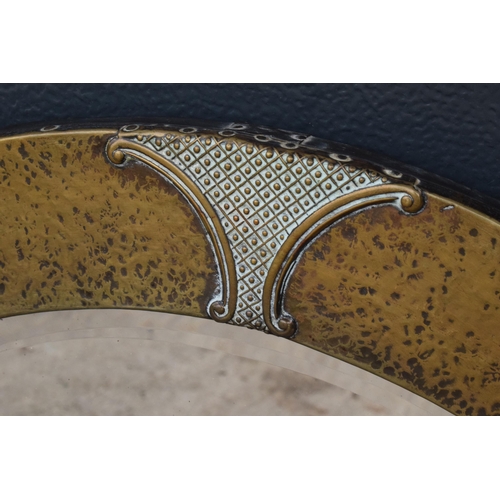 352 - A large late 19th / early 20th century Arts and Crafts hammered brass circular wall mirror. Approx 5... 