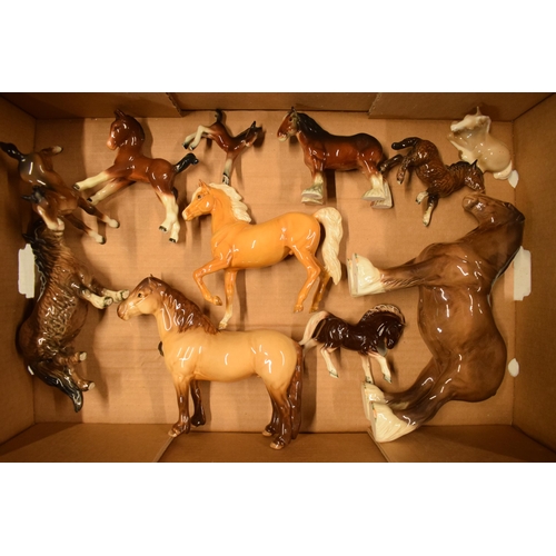 143 - A collection of Beswick horses to include brown 818 shire, highland pony, palomino prancing arab and... 