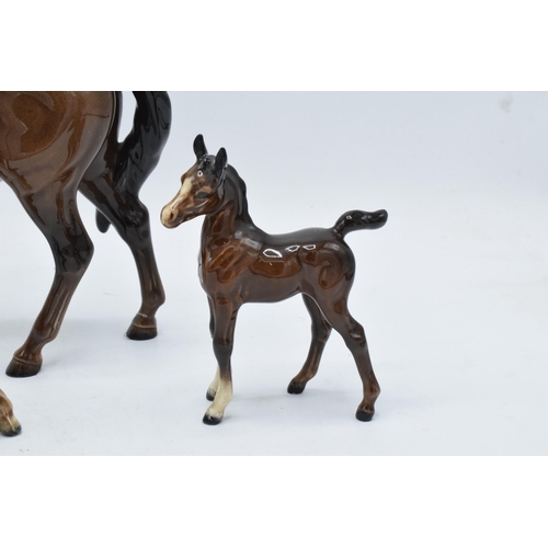 144 - A collection of brown Beswick horses and foals to include mare facing left 976, early Shetland foal,... 