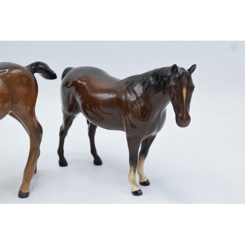 145 - A trio of brown Beswick horses to include leg tucked horse 1549, mare facing right 991 and a large s... 