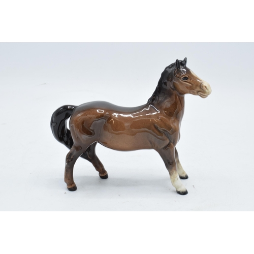 148 - Beswick brown girls pony 1483. In good condition with no obvious damage or restoration.