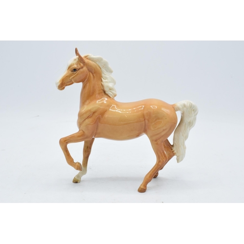 153 - Beswick palomino prancing Arab horse 1261. 17cm tall. In good condition with no obvious damage or re... 