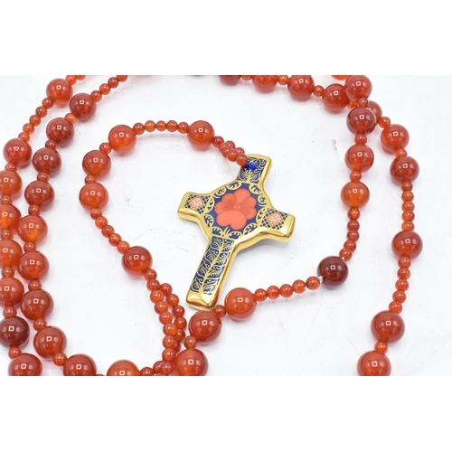 179 - Royal Crown Derby Imari Rosary Cross pendant set on an orange-beaded necklace, complete with box. As... 