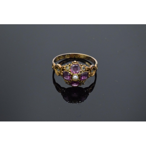 203F - Victorian 12ct gold ladies ring set with a seed pearl and amethyst stones. 1.7 grams. UK size O.