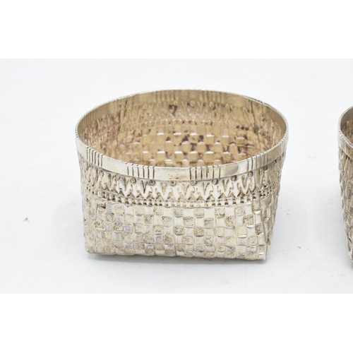 210 - A pair of foreign silver bon bon dishes with patchwork decoration. Tested as low grade silver. 105.4... 