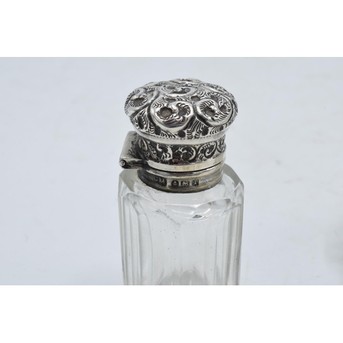 222 - A silver topped scent bottle with a stopper (Birmingham 1910) together with a sterling silver topped... 