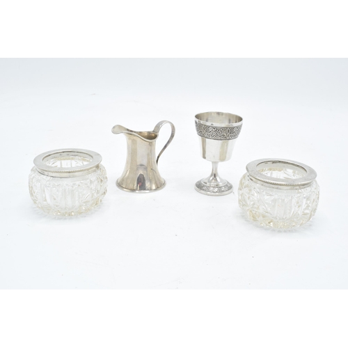 231 - A collection of silver items to include a pair of silver topped salts (London 1900), a miniature cre... 