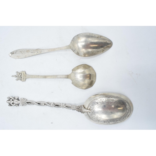 245 - A collection of spoons to include a Paul Orr Madras Indian silver serving spoon, Selangor preserve s... 