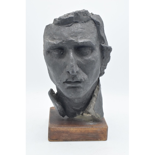 253 - A 20th century studio-made bust of a gentleman mounted on a wooden base. 34m tall.