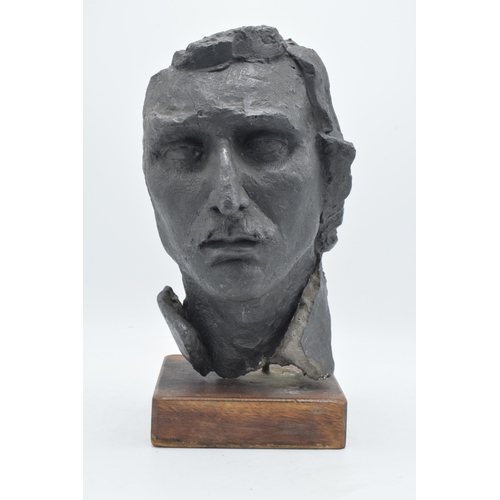 253 - A 20th century studio-made bust of a gentleman mounted on a wooden base. 34m tall.