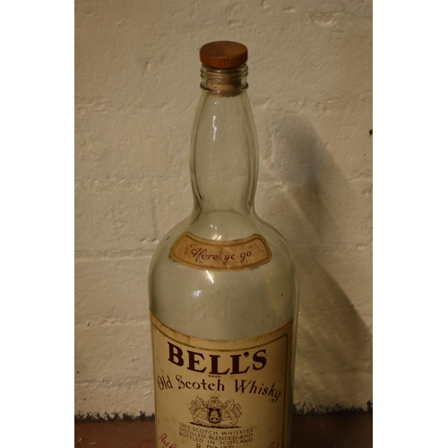 254 - A large vintage Bells Old Scotch Whiskey bottle. 51cm tall.