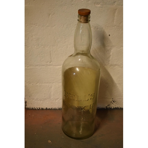 254 - A large vintage Bells Old Scotch Whiskey bottle. 51cm tall.