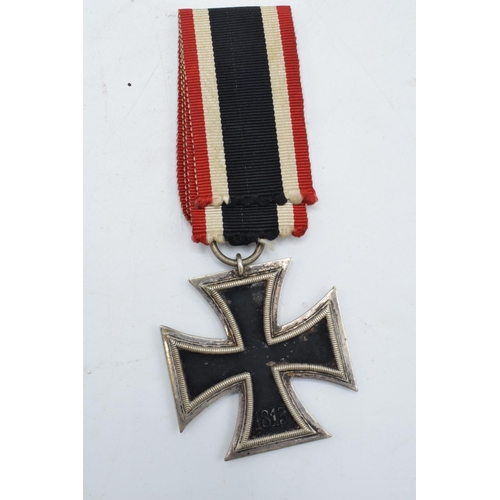 273 - A collection of German Militaria to include a WW2 iron cross and ribbon, a reproduction Nazi cap bad... 