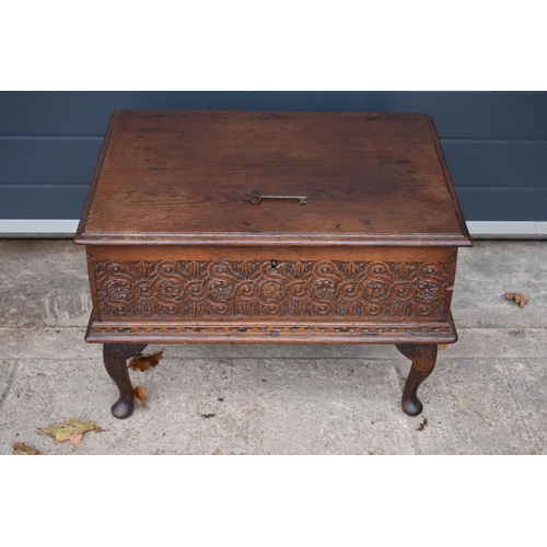 294 - A late 18th / 19th century oak bible box raised on cabriole style legs with heavy carved decoration ... 