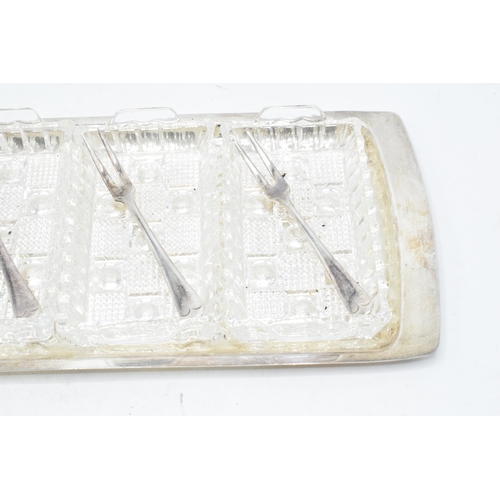 312 - Silver plated 4 section glass hors d'oeuvres tray with 4 matching forks. 39cm long.