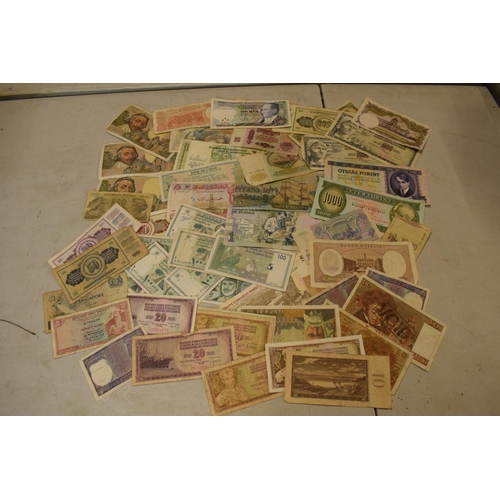 317 - A mixed collection of bank notes from across the world to include examples from Singapore, Ghana, Fr... 