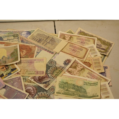 317 - A mixed collection of bank notes from across the world to include examples from Singapore, Ghana, Fr... 