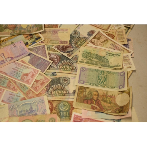 317 - A mixed collection of bank notes from across the world to include examples from Singapore, Ghana, Fr... 