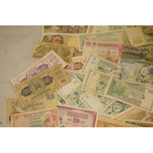 317 - A mixed collection of bank notes from across the world to include examples from Singapore, Ghana, Fr... 