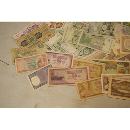 317 - A mixed collection of bank notes from across the world to include examples from Singapore, Ghana, Fr... 