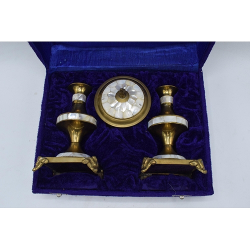 319 - A cased 20th century brass garniture candlesticks set with lidded trinket with mother of pearl inlay... 