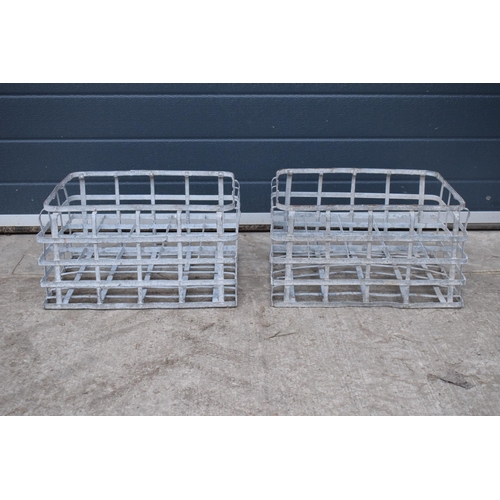 343 - A pair of vintage metal stacking milk crates. Each to hold 16 bottles. Approx 44 x 35cm.