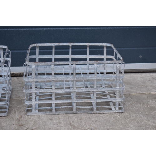 343 - A pair of vintage metal stacking milk crates. Each to hold 16 bottles. Approx 44 x 35cm.