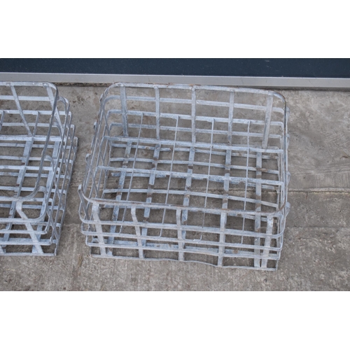 343 - A pair of vintage metal stacking milk crates. Each to hold 16 bottles. Approx 44 x 35cm.