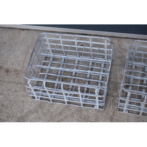 343 - A pair of vintage metal stacking milk crates. Each to hold 16 bottles. Approx 44 x 35cm.