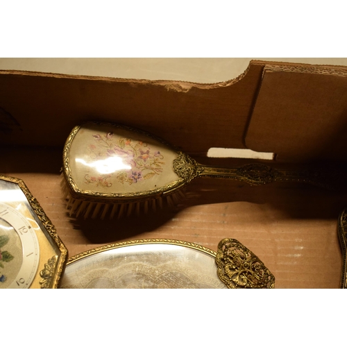 347 - A 20th century ornate gilt metal dressing table set to include a tray, brushes, clock, trinkets etc.... 