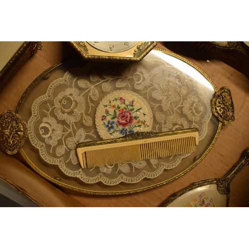 347 - A 20th century ornate gilt metal dressing table set to include a tray, brushes, clock, trinkets etc.... 