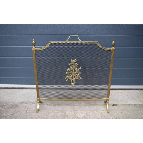 357 - A brass and metal fire guard with armorial or similar badge to front. 67 x 68cm tall.