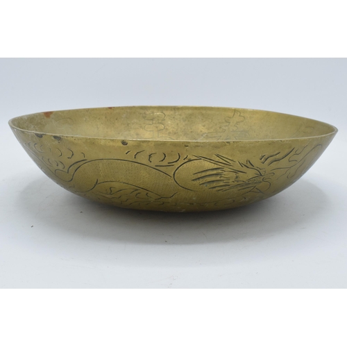 387 - A 20th century brass bowl with Chinese markings and decoration. 30cm diameter.