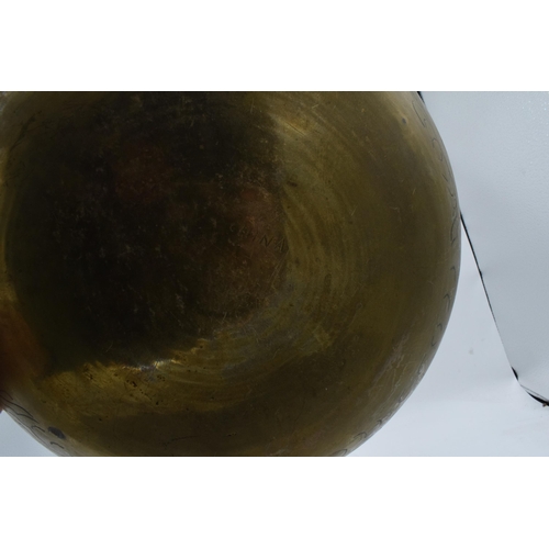 387 - A 20th century brass bowl with Chinese markings and decoration. 30cm diameter.