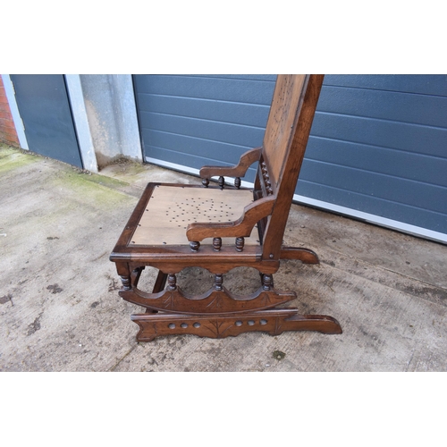 390 - Edwardian wooden spring-action American-style rocking chair with turned decoration. 96cm tall. In go... 