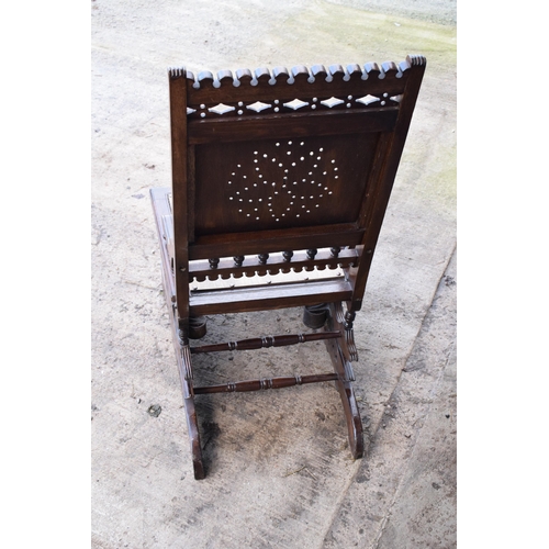 390 - Edwardian wooden spring-action American-style rocking chair with turned decoration. 96cm tall. In go... 