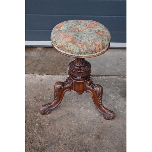 391 - A 19th century walnut carved piano stool with upholstered adjustable seat together with a matching c... 