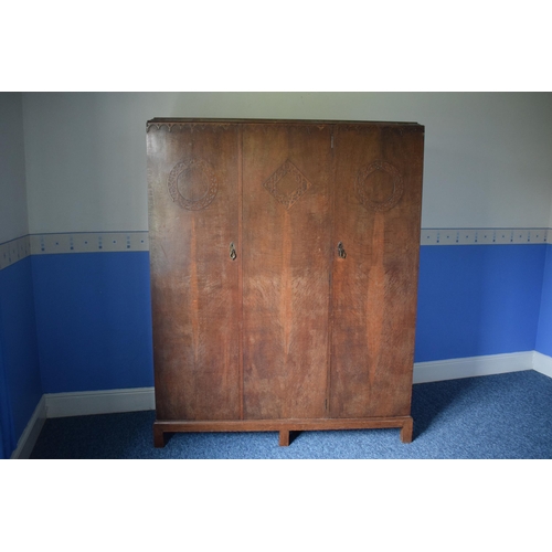 393 - Early 20th century wooden triple wardrobe with decoration to panels. 154 x 48 x 187cm tall. In good ... 