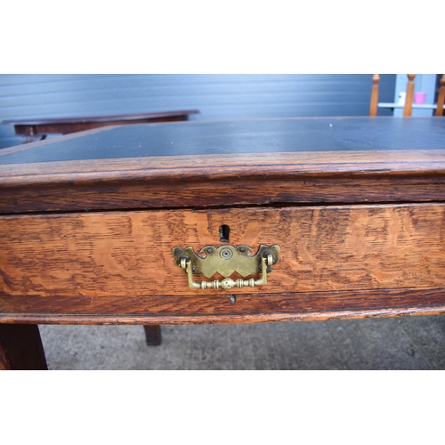 397 - A late 19th / early 20th century wooden desk with a black leather inset with 2 drawers. 123 x 76 x 7... 