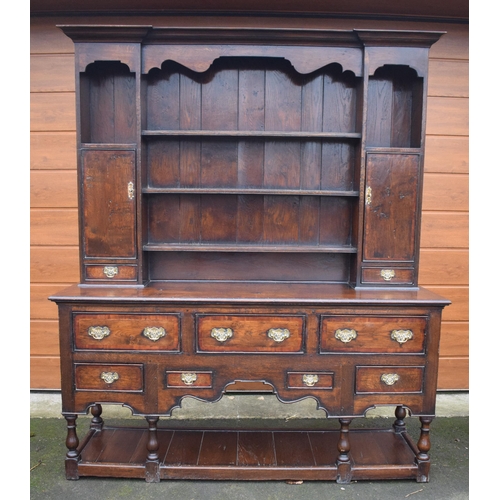 Late 19th century oak dresser and rack of fine quality in the 18th century style of good proportions with panelled back and varying sizes of drawers to the front. 168 x 48 x 200cm tall. In good functional condition with working locks and some knocks, scuffs, marks, old worm etc.